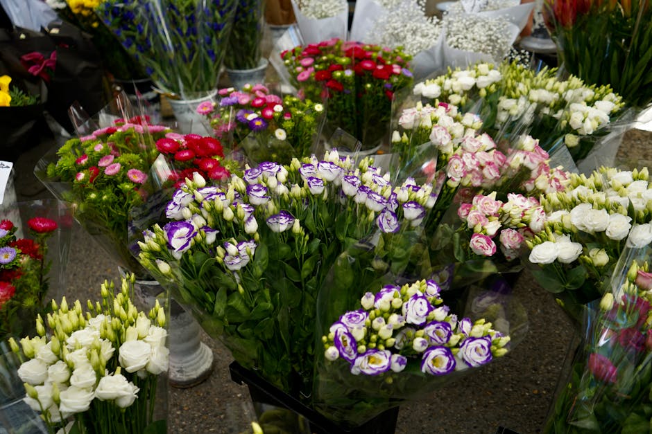 A vibrant display of freshly arranged flowers at westhampsteadflowers.co.uk, featuring a variety of colorful blooms including purple and white irises, pink and white lisianthus, red and pink chrysanth